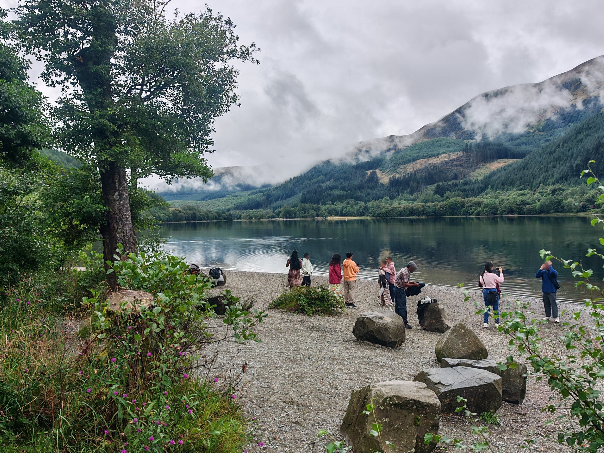 A family enjoying the shore of Loch Lubnaig on a private day tour